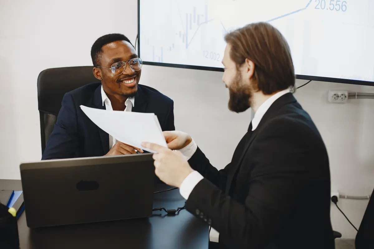 Two business partners reviewing documents